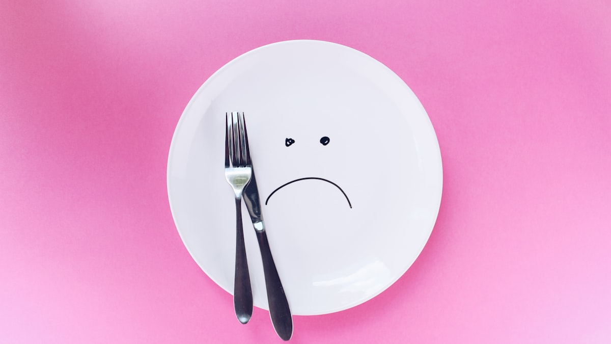 An empty plate with a sad face drawn on it — the delivery never arrived