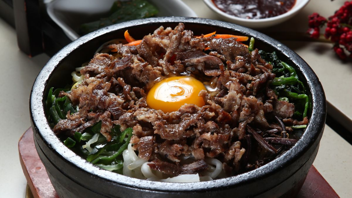 Korean bibimbap in a bowl with vegetables and egg
