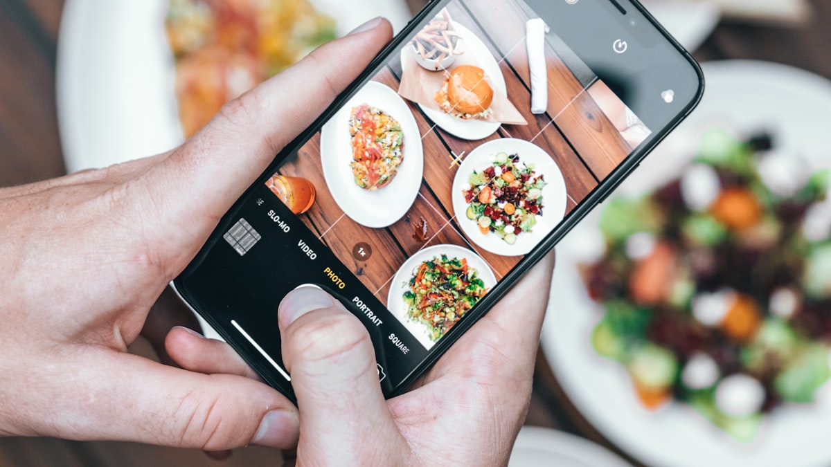 Person happily ordering food on their phone
