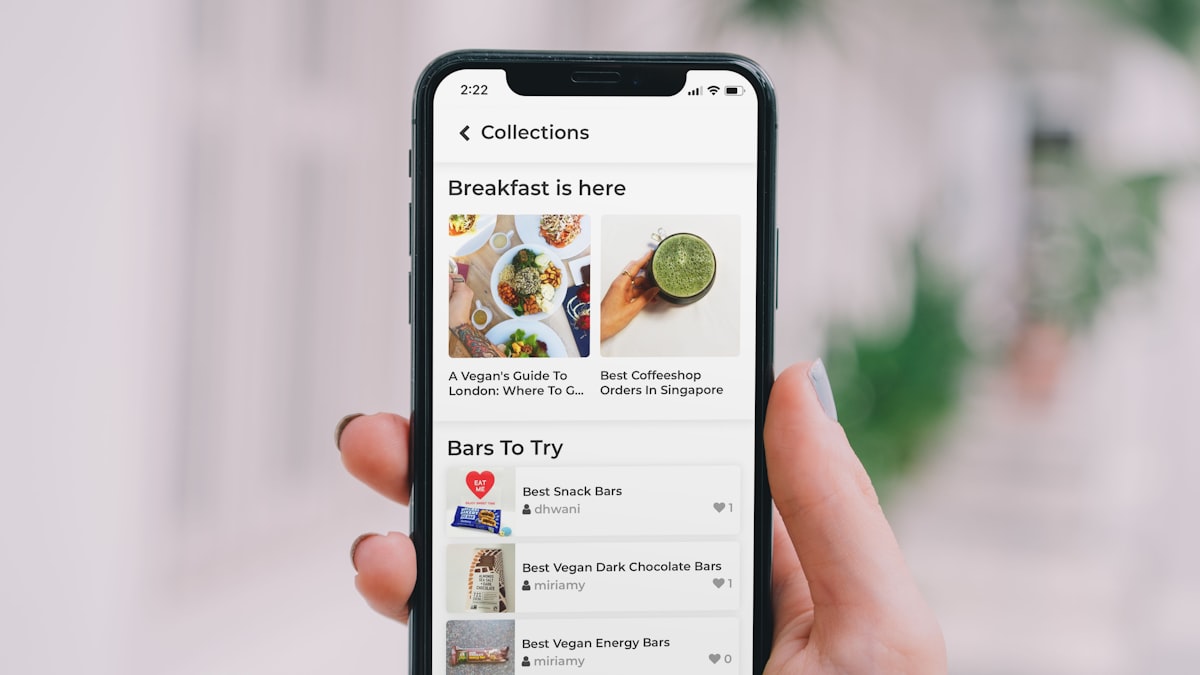 Hand holding a phone with a food ordering app open