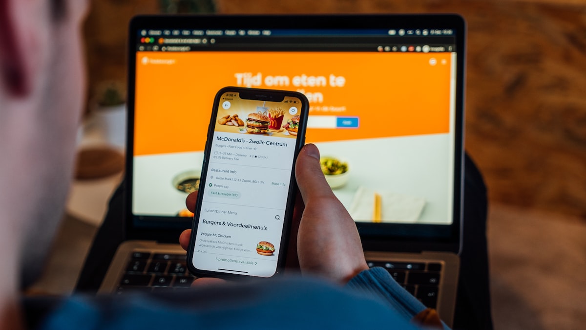Phone with a food delivery app — checking you are on the real site