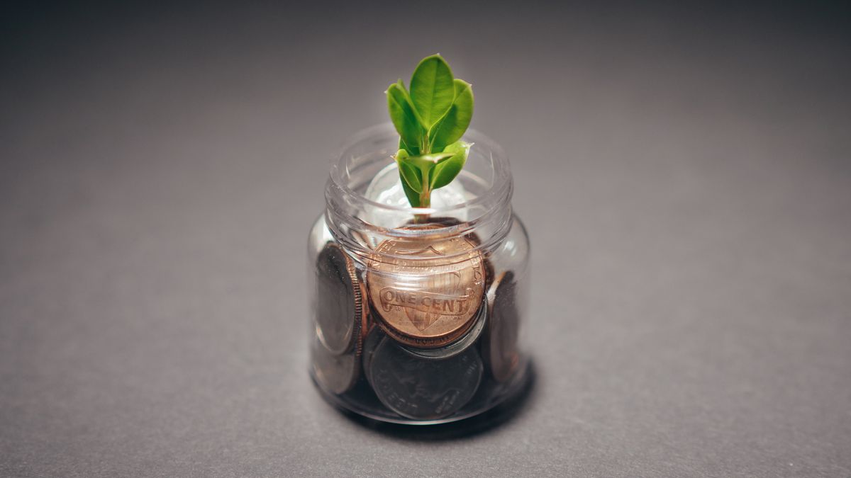 Coins in a glass jar representing saving money on food